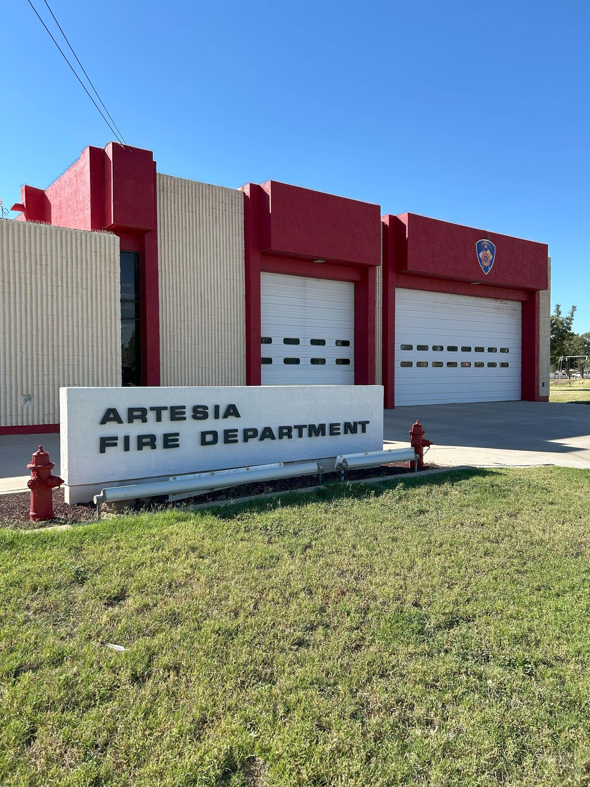 The remodeled station 2 building with a sign that says Artesia Fire Department in front of it